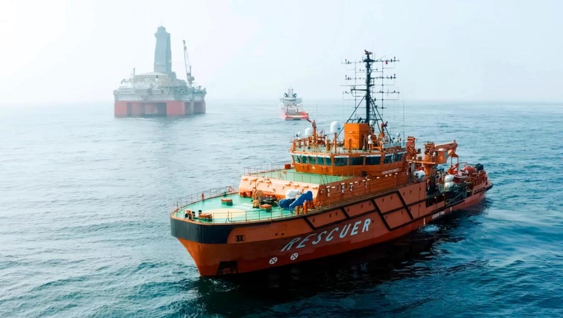 Eine Öl-Plattform auf See und in der Nähe davon ein Service-Schiff (Zoonar.com / Olga Kostrova)