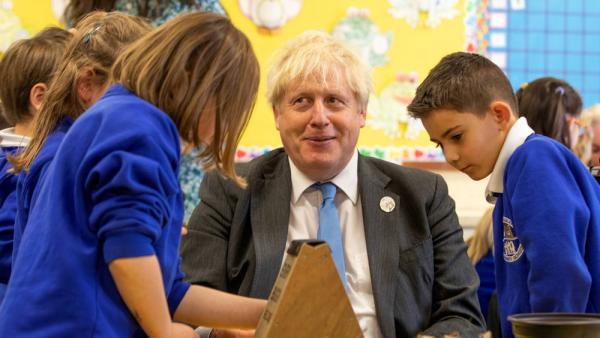 Der britische Premierminister Boris Johnson bei einem Besuch einer Grundschule in der Grafschaft Antrim, wo er zusammen mit Schulkindern ein Insektenhotel baut, 21.10.2021 (IMAGO / ZUMA Press)